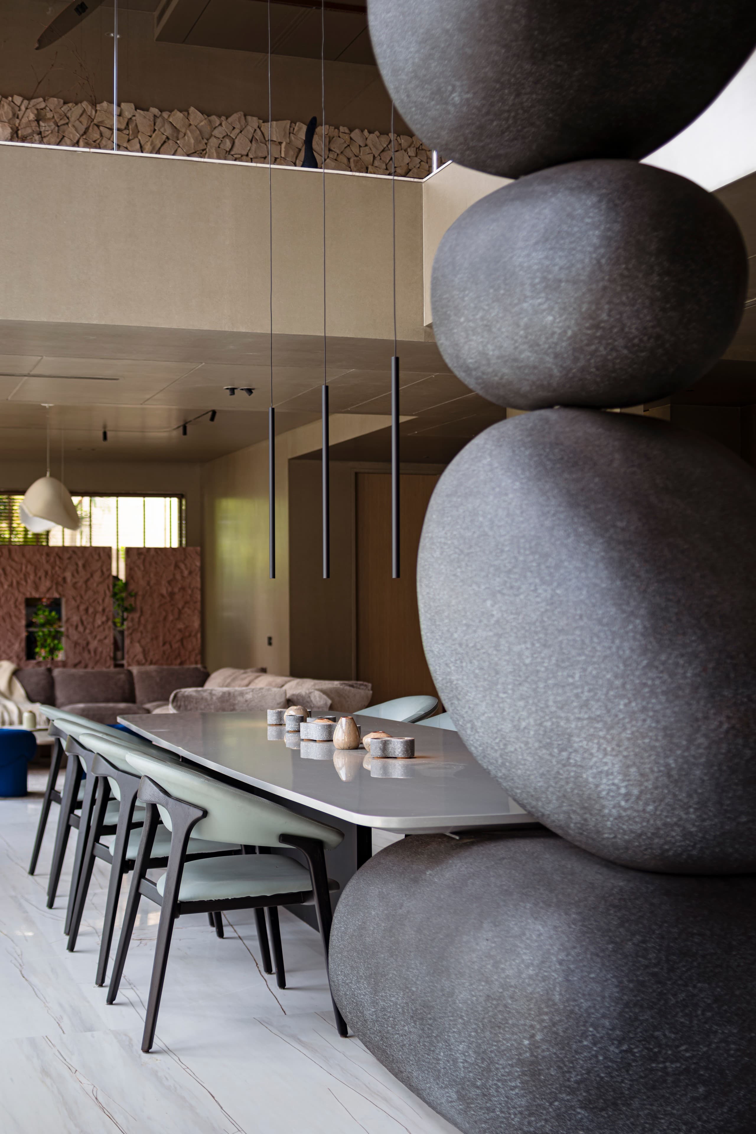 Rounded stone vessels grouped on the dining table.